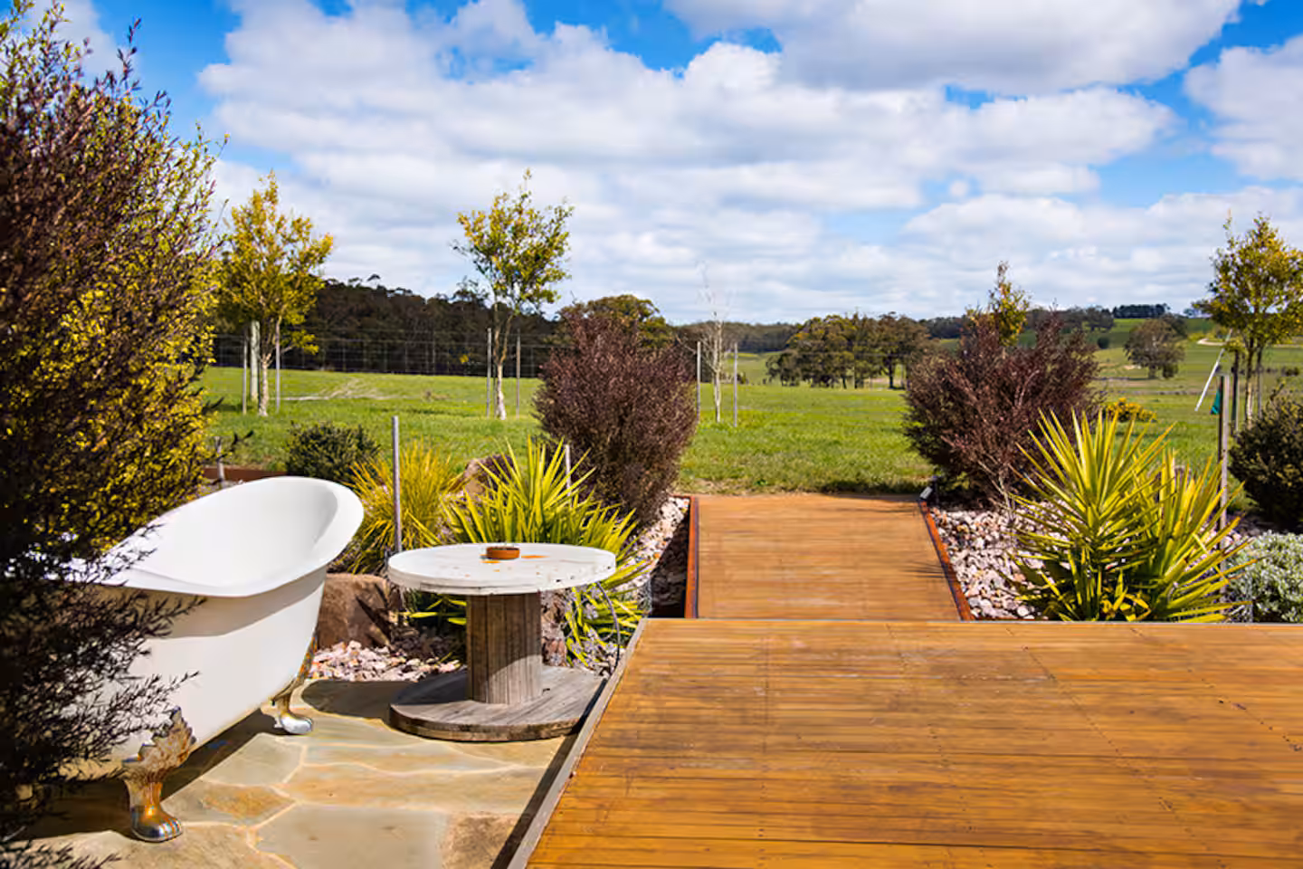 Freestanding outdoor bath on the studio deck with rural valley views